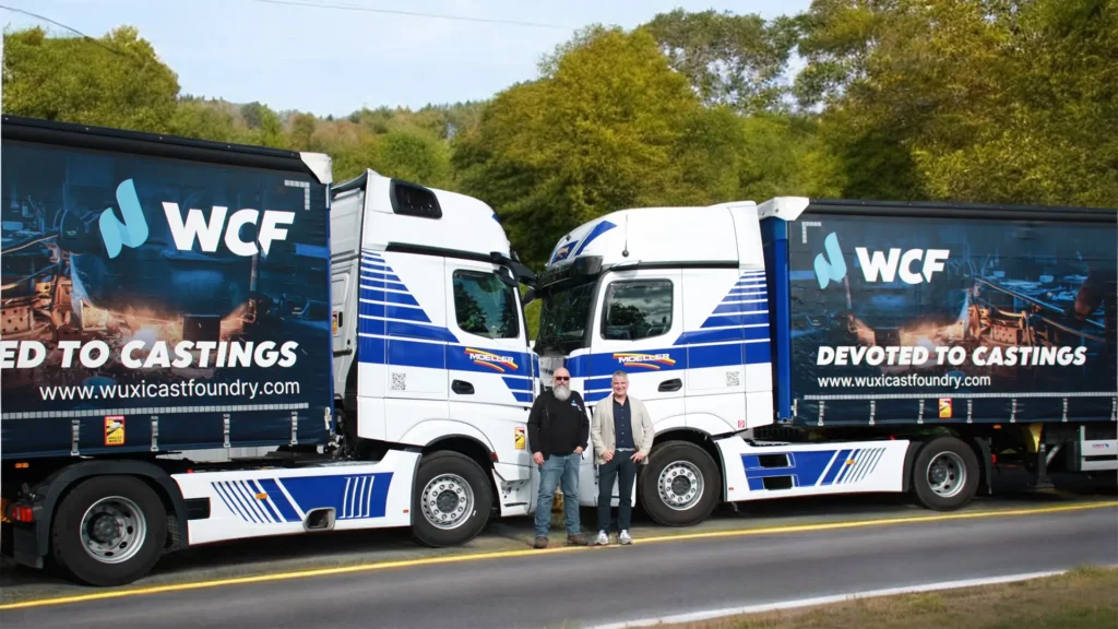 Michael König in front of two trucks